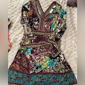 Colorful, knee length dress. Long sleeved. Belt ties in the back. Very stylish!